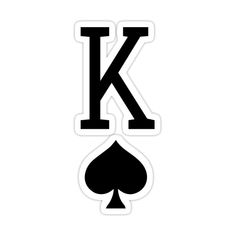 the letter k is made up of two playing cards and a spade sticker on top of it