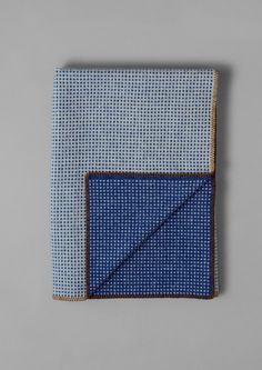 a blue and white pocket square on a gray background