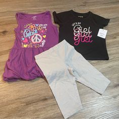 Purple Tank Top Dress Like Shirt Is Brand Extremely Me!, Size 5/6, Is Cinched At Sleeves With Fabric Band And At Bottom Hem With Elastic. Top Is In Euc. Black Shirt Is Jumping Beans Active, Size 5t, And Nwt. Silver Sparkle Shorts Are Bermuda (Knee) Length, Cartwheel Style, And Are 365 Kids Brand And A Size 5. Playful Stretch Black Tops, Playful Black Stretch Top, Cute Short Sleeve Purple Set, Black Playful Stretch Top, Stretch Black Tops For Playwear, Black Stretch Tops For Playwear, Playful Fitted Purple Tops, Casual Stretch Sets For Playwear, Pink Stretch Top For Playtime