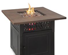 an outdoor fire pit with flames burning on the top and side panels, in front of a white background