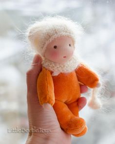 This Waldorf doll is 6,5 inches (16 cm) tall perfect for dollhouse games. She has ginger color jumpsuit made of cotton velour(80% cotton,20% polyester). A removable scarf is made of mohair and the hat is securely stitched to the head.  Her skin material is 100% cotton Swiss jersey, her face is knit with simple hand-embroidered facial features, and has rosy cheeks. This soft baby doll is filled with clean sheep's wool. Crochet Waldorf Doll Free Pattern, Needle Felted Waldorf Dolls, Mini Waldorf Doll, Waldorf Dolls For Sale, Waldorf Pocket Doll Pattern, Fluffy Hat, Ginger Color, Tiny Waldorf Doll, Pocket Doll