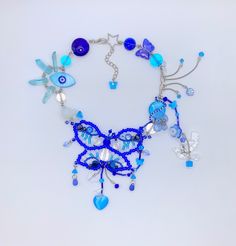 a necklace with blue beads and charms on it