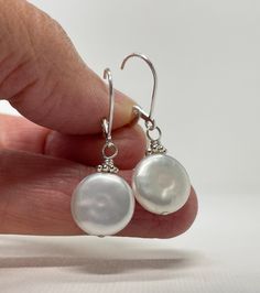 Coin Pearl Earrings. Sterling Silver Leverback Earrings. June Birthstone Gift for Her. The earrings are handmade using sterling silver and freshwater pearl components. The pearls are coin shaped and measure ~12 mm wide, they are white pearls with subtle pink overtones and a few natural bumps and wrinkles are seen in the surface. The pearls are complemented by bright Bali daisies. Total length of the earrings is 1 3/16 inch (3.0 cm) for French hook and 1 5/16 inch (3.3 cm) for leverback. Choose e Adjustable Pearl Charm Earrings As Gift, Everyday Pearl White Sterling Silver Jewelry, Nickel-free Teardrop Pearl Earrings For Anniversary, Nickel Free Teardrop Pearl Earrings For Anniversary, Handmade Adjustable Pearl White Earrings, Everyday Nickel Free Pearl Jewelry, Everyday Handmade Teardrop Pearl Earrings, Everyday Nickel-free Pearl Jewelry, Hypoallergenic Pear-shaped Sterling Silver Jewelry