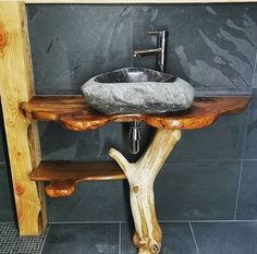 a bathroom sink made out of wood and stone