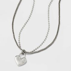 Accessorize your casual attire with this Heart Charm with Chain Necklace from Universal Thread™. The silver-tone necklace is composed of two chains and comes adorned with a heart charm dangling down at the center for a lovely look. With a lobster-clasp closure and an extender chain that lets you customize the length to your liking, this two-chain necklace is easy to pair with an array of necklines for versatile styling options you're sure to appreciate. Universal Thread™: The denim collection th Trendy Silver Heart Necklace With Lobster Clasp, Trendy Silver Charm Necklace With Heart Charm, Trendy Silver Necklace With Heart Charm, Denim Collection, Casual Attire, Universal Thread, A Heart, Heart Charm, Lobster Clasp