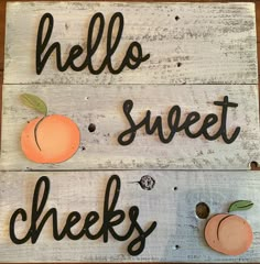 two wooden signs with the words hello sweet cheeks and an orange painted on one side