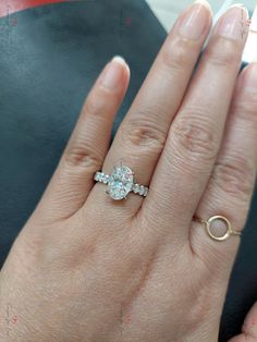 a woman's hand with a ring on it and a diamond in the middle