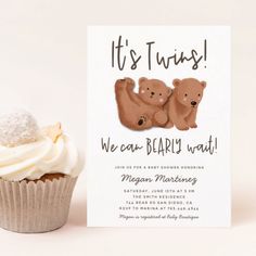 a cupcake with frosting on it next to a card that says it's twins