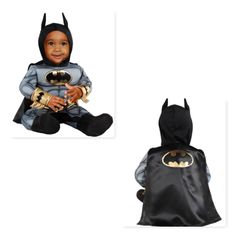 a little boy dressed as batman sitting on the ground