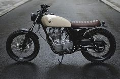 a white and brown motorcycle parked on the street