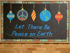 a sign that says let there be peace on earth hanging from the side of a brick wall