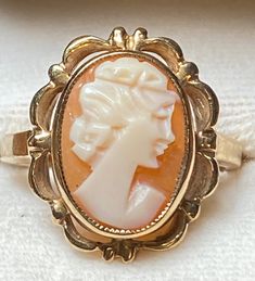 Vintage 10K yellow gold cameo ring for your consideration. The star of the show is the cameo.  It is set in a decorative bezel setting right with a right facing lady.  The scalloped frame provides detail and interest.  The setting 18mm tall and 14.5mm wide.  The band measures 1.9mm in the back.  It is a size 6 1/2 and weighs 3.72 grams. It is a truly beautiful ring! Cameo 14k Gold Rings For Collectors, Collectible 14k Gold Cameo Rings, 14k Gold Cameo Rings For Collectors, Sweet Jewelry, Mom Ring, Cameo Ring, Butterfly Ring, Ring Fit, Bezel Setting