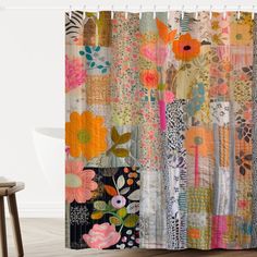 the shower curtain is decorated with colorful flowers