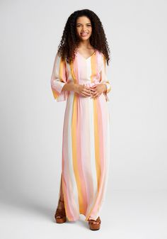 All the sweetness of summer is simply radiating from the creamy sorbet-esque hues of this ModCloth x Collectif collab striped maxi dress ! Made from a lightweight woven fabric with a vintage-inspired vertical stripe design in delicious shades of pink, white, and yellow, this beautiful floor-length dress boasts a V-neckline, elbow-length sleeves with delicate asymmetrical detailing at the cuff, and a retro-fab waistline that is sweetly cinched by a pink-hued adjustable belt. Elegant enough for a Beach White Maxi Dress With Vertical Stripes, Striped V-neck Maxi Dress For Spring, Spring Vertical Striped Maxi Dress, Summer Maxi Dress With Vertical Stripes, Spring Beach Dresses With Vertical Stripes, Spring Summer Dress With Vertical Stripes, Vertical Stripes Dress For Summer, Spring Maxi Dress With Vertical Stripes, Spring Vertical Stripes Maxi Dress