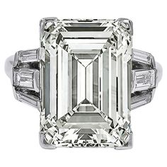 A stunning engagement ring boasting an emerald-cut diamond weighing 11.96 carats. Accompanied by a GIA report stating that the diamond is of O-P color, VS1 clarity. 6 tapered baguette diamonds on the sides. Metal is 18k white gold. Gross weight is 7.06 grams. Size 6.5. Sizable. Ruby Diamond Engagement Ring, Classic Diamond Engagement Ring, Emerald Cut Diamond Engagement Ring, Emerald Cut Diamond Engagement, Contemporary Engagement Rings, Emerald Cut Diamond Ring, Expensive Jewelry Luxury, Emerald Diamond Ring, Stunning Engagement Ring