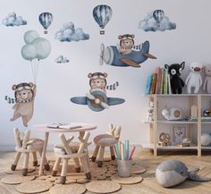 a child's room with wall decals and toys