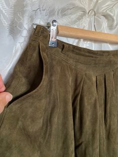 Original vintage 1980s olive green flared mini skirt with pockets and belt loops. Fully lined. Beautifully tailored pleat-like structuring at front and back. Even has a bit of swing to it. Suede has nice worn in feel, but still looks in excellent condition with virtually no flaws noted. button and zip up back. Waist is 72cm all round. Length is 49cm I'd say an 8-10 Aus. Olive Green Mini Skirt, Flared Mini Skirt, Green Mini Skirt, Vintage Suede, Skirts With Pockets, Olive Green, Mini Skirt, Zip Ups, Art Collection