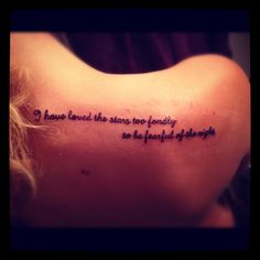 the back of a woman's shoulder with a quote written on it