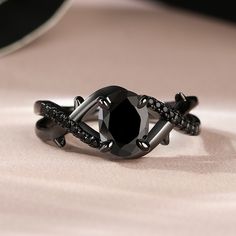 a black diamond ring sitting on top of a table