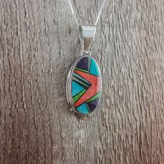 Rick Tolino Inlay Pendant – Santa Fe Silver Art Multicolor Cabochon Gemstones, Multicolor Cabochon Gemstones In Sterling Silver, Unique Multicolor Oval Gemstones, Multicolor Inlay Southwestern Necklace, Unique Oval Inlay Jewelry, Unique Oval Jewelry With Inlay, Artisan Multicolor Jewelry With Inlay, Unique Multicolor Sterling Silver Gemstones, Unique Multicolor Gemstones In Sterling Silver