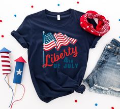 Liberty 4th of July T-shirt American Flag T-shirt For 4th Of July, Patriotic American Flag Print T-shirt For Summer, Red Americana T-shirt With American Flag, Summer Americana Style Short Sleeve T-shirt, Patriotic Beach Tops With Flag Print, Patriotic Red Tops For Beach, Patriotic Beach Tops For 4th Of July, Red Top For 4th Of July Beach Outing, Red Top For Beach And 4th Of July