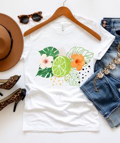 This t-shirt is perfect for spreading summer vibes and good cheer with its vibrant fruit and hibiscus flower design. It is also the ideal gift for anyone who loves to embrace the sunny season and bring a touch of tropical joy to their wardrobe. ♥PRODUCTION TIME: 1-5 days (usually 2-3 days) ♥SHIPPING TIME: 2-5 days (usually 3 days) ♥PRODUCT DESCRIPTION: Bella Canvas Unisex T-shirt Super soft cotton and excellent quality print makes. 100% Soft cotton (fibre content may vary for different colors) L Hibiscus Flower Design, Fruit Shirt, Sunny Season, Lemon Fruit, Cruise Shirt, Clothing Summer, Beach Shirt, Hibiscus Flower, Summer Clothing