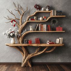 a wooden tree shelf with books and vases on it