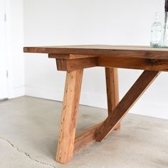 a wooden table sitting on top of a cement floor