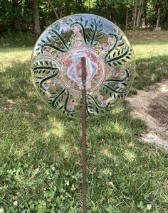 a decorative glass object in the grass