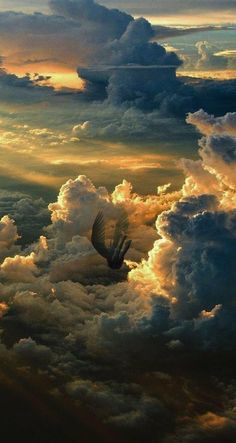 a hot air balloon flying in the sky with clouds and sun shining down on it