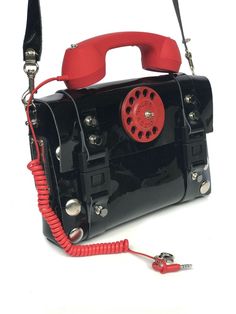 30% OFF WAS $250 NOW $175 Industrial design, wearable art Fashionista Steampunk black leather bag in telephone design. True piece of art and conversation starter. Size is designed to accommodate standard tablet.] Handmade item. Bag material PU coated leather Retro telephone decorative handle Aluminum telephone dail ,with hi tek logo. Width 29.50 cm or 11 4/8 inches Height without the telephone 21 cm or 8 2/8 inches Designer Black Satchel With Mobile Phone Bag, Designer Black Bags With Hardware, Vintage Black Satchel With Mobile Phone Bag, Retro Telephone, Steampunk Black, Telephone Design, Black Leather Bag, Novelty Bags, Vintage Purses