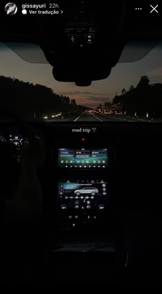 the interior of a car at night with its lights on and dashboard illuminated by headlights