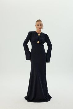 This Elegant Black Formal Evening Dress is designed to make a statement with its timeless silhouette and bold detailing. Perfect for those who appreciate understated elegance and modest fashion, this long-sleeve gown is ideal for formal events, galas, or evening occasions. Features: Luxurious Fabric: Crafted from premium fabric that offers both comfort and a sophisticated drape, this gown ensures an elegant fit. Statement Gold Buttons: The gold button detailing at the front adds a striking focal Party Dress Modest, Sophisticated Party, Evening Gala, Formal Parties, Dress Modest, Flare Long Sleeve, Modest Dress, Formal Evening Dress, Black Formal