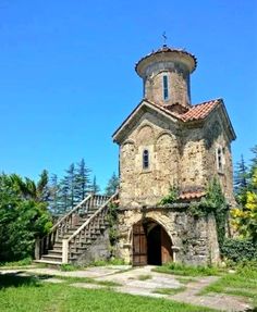 an old stone church with stairs leading up to it