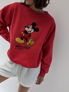 Vintage 90s nostalgic perfectly worn in Mickey Mouse pullover features a round neckline with micro ribbed detailing and an embroidered Mickey Mouse logo on the front. Perfectly paired with our waffled cotton shorts, your favorite ball cap, new balances, and your gold-toned jewelry. Tag reads Mickey Inc Subtle spots of lightening at the front middle. Vintage Disney Crewneck, Old Money Disney Outfits, Chic Disneyland Outfits, Classic Disney Aesthetic, Trendy Streetwear Tops With Embroidered Logo, Trendy Streetwear Top With Embroidered Logo, Trendy Embroidered Logo Top For Streetwear, 90s Crew Neck Top With Embroidered Logo, Relaxed Fit Top With Embroidered Logo For Loungewear