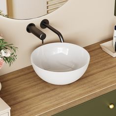 a white bowl sink sitting on top of a wooden counter