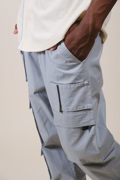 Stay up to date with all the fashion fads and bring Y2K styles back to your wardrobe with our Multi-Pocket Poplin Cargo Pant. Whether you work a blue-collar job or just love the aesthetic, a utilitarian and versatile cargo pant is a must-have staple for any streetwear-loving man. Grab a pair and unlock the limitless style options men’s cargo pants offer. Designed with one of our high-quality fabric blends to keep you comfortable with every wear, this pair of pants will keep you feeling and looki Cargo Pants Sale, Loving Man, Cloth Shop, Men's Bottoms, Cargo Pant, Y2k Style, Stay Up, Pair Of Pants, Up To Date