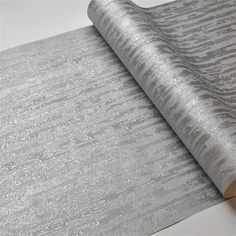 a roll of silver glitter paper on top of a white table