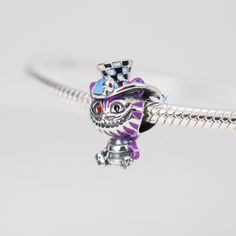 This is charm only, bracelet is sold separately.The charm features Alice in Wonderland's Cheshire cat character with its distinctive mischievous grin, made of solid 925 sterling silver and enamel color decoration. Add this charm to your charm for bracelet collection or as gift for your love one. The Cheshire Cat charm is a delightful addition to your bracelet collection, showcasing the playful spirit of Alice in Wonderland. Made of high-quality 925 sterling silver and adorned with vibrant enamel Whimsical Silver Charms For Gifts, The Cheshire Cat, Magic Cat, Color Decoration, Cat Character, Cat Charm, Casting Jewelry, Silver Charm Bracelet, For Your Love