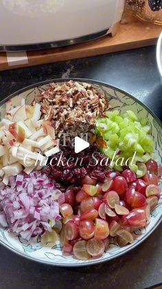 a bowl filled with fruit and nuts on top of a counter next to a microwave