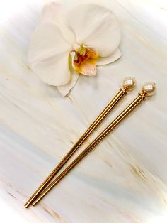 "Lovely Swarovski Pearls adorn the ends of these elegant hair sticks. Perfect for a wedding updo or bridal party gift. Our hair sticks have proven over the last 20 years to be the best on the market here's why: Strong, lightweight metal base sticks Approved for use in wet or damp hair All edges smoothed for a safe, snag free hold NO flimsy cheap head pins to bend our break No lead containing cheap imported spacer beads Genuine high quality jewelry grade gemstones Shown on our gold metal hair sti Jeweled Hair, Bridal Hair Pins Pearl, Bridal Hair Pin, Luxury Hair Accessories, Sweater Pin, Gold Hair Pin, Hair Jewels, Shawl Pin, Pearl Hair Pins