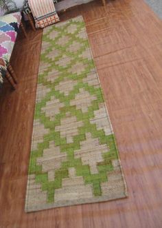 a living room with a couch and rug on the floor