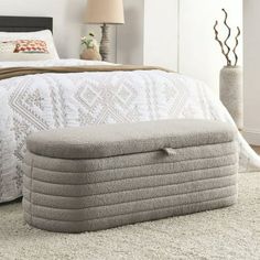 an inflatable mattress is sitting on the floor next to a bed with pillows