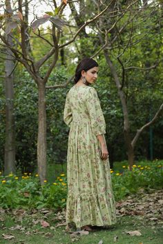 This Green Muslin Silk Floral Anarkali Dress makes a beautiful statement. Embellished with stylized buttons, beads, stones, and mirror work for eye-catching detailing. Pleated Anarkali dress with balloon sleeves, and a cotton voile lining for comfort. Make a show-stopping entrance in this stunning dress. Green Muslin silk Length 55" inches Floral pattern Ballon sleeves V-neck Pull on Anarkali dress with lining Dry clean Fit: True to sizeInside Margin: NoTouch and Feel: Soft and ComfortableDispat Bollywood Style Straight Kurta Dress With Mirror Work, Pista Green Dresses With Printed Motifs For Eid, Floor-length Dresses With Mirror Work, Pista Green Dress With Printed Motifs For Festivals, Festive Anarkali Maxi Dress With Chikankari Embroidery, Festive Pista Green Dress With Printed Motifs, Anarkali Dress With Chikankari Embroidery In Pista Green, Pista Green Maxi Dress With Resham Embroidery, Anarkali Maxi Dress With Chikankari Embroidery