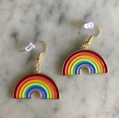 Gold enamel backed rainbow earrings are perfect for bringing in that pop of color and looking absolutely adorable next to your beautiful face! Coffee Earring, Mad Hatter Costume, Pride Jewellery, Handmade Candy, Bat Earrings, Rainbow Jewelry, Sparkly Earrings, Rainbow Earrings, Colorful Earrings