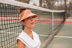 The Clementine in red is made for the lighthearted, the colorful, and the happy. She's useful just as much as she is stylish. This straw visor keeps the sun out of your eyes on the beach, playing tennis, or lounging by the pool. The Panama straw is woven from natural toquilla straw grown in Ecuador and woven by a single weaver each time, which takes several hours to complete. The straw is then shipped to the US and blocked in the US. The tie closure is made with ribbon. Playful Summer Visor Hat, Playful Red Summer Hat, Fun Summer Visor Sun Hat, Summer Red Visor Hats, Red Visor Hats For Summer, Adjustable Summer Tennis Hat, Adjustable Tennis Hats For Summer, Casual Summer Tennis Hat, Straw Visor