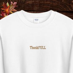 It's ThankFULL season! Thanksgiving, crewneck sweatshirt,  with high quality embroidered lettering. Perfect for Thanksgiving, Friendsgiving or anytime you want to look cute while you fill:) A pre-shrunk, classic fit sweater that's made with air-jet spun yarn for a soft feel and reduced pilling. * 50% cotton, 50% polyester * Pre-shrunk * Classic fit * 1x1 athletic rib knit collar with spandex * Air-jet spun yarn with a soft feel and reduced pilling * Double-needle stitched collar, shoulders, armholes, cuffs, and hem White Hoodie With Embroidered Graphics For Fall, Oversized Letter Embroidery Sweatshirt For Winter, Oversized Fall Sweater With Letter Embroidery, Oversized Winter Sweatshirt With Letter Embroidery, Oversized Letter Embroidery Sweater For Fall, Winter Oversized Embroidered Sweatshirt, Oversized White Sweatshirt With Letter Embroidery, Fall College Sweatshirt With Embroidered Text, College Fall Sweatshirt With Embroidered Text