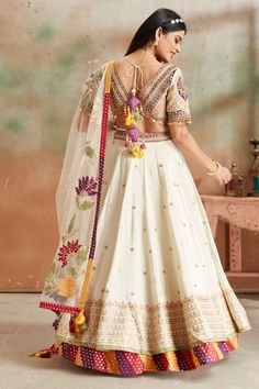 Go for a beautiful traditional look at weddings in this cream embroidered Banarasi silk lehenga with multicolor border. The lehenga comes with a beautiful dupatta. Eid Banarasi Silk Lehenga With Embroidered Border, Transitional Lehenga With Embroidered Border In Silk, Semi-stitched Banarasi Silk Lehenga With Border, Bohemian Cream Dupatta With Embroidered Border, Semi-stitched Banarasi Silk Lehenga With Embroidered Border, Lehenga Online, Fashion Journals, Tussar Silk Saree, Silk Lehenga