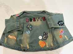 PERSONALIZED DENIM JACKET <3 Custom Name Patch  <3 Personalized Baby Toddler Kids Denim Jacket  <3 Birthday Gifts <3 Holiday Gifts Include this personalization information with your order: 1) Name/phrase you want on jacket 2) Pick 3-4 patches 3) additional patches will be additional cost  **I love doing custom pieces so if you don't see it here. Please message me and I will try my best to make it happen Trendy Multicolor Letter Print Outerwear, Multicolor Denim Jacket With Patches For Spring, Multicolor Patched Denim Jacket For Spring, Trendy Green Denim Jacket For Spring, Trendy Letter Print Denim Jacket For Spring, Spring Denim Jacket With Patches For Streetwear, Spring Streetwear Denim Jacket With Patches, Trendy Spring Denim Jacket With Letter Print, Retro Spring Outerwear With Patches