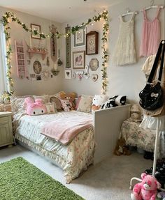 a bedroom decorated in pink and white with pictures on the wall